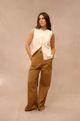 Pantalón de corte ancho y holgado, color ocre, con bolsillos frontales aplicados y costuras pespunteadas visibles.