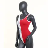 Malla enteriza de natación Fila, color azul marino con ribetes blancos y logo de la marca estampado en el pecho.