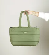 Bolso tipo tote acolchado de color verde oliva, con diseño de costuras horizontales y logo de la marca estampado en el frente. Cuenta con dos asas superiores reforzadas y cierre superior.
