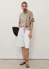 Short estilo jort de tiro medio y corte recto, confeccionado en tejido de algodón estilo tejano. Cuenta con cierre de cremallera y botón, trabillas para cinturón y cuatro bolsillos funcionales.