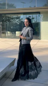 Falda larga de tul negro con diseño de capas y terminación en encaje floral en el ruedo.