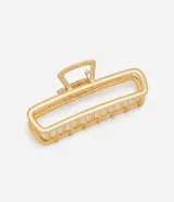 Pinza para el pelo de diseño rectangular con estructura rígida y laterales abiertos. Fabricada en aleación de zinc con acabado en tono dorado claro.