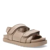 Sandalias planas color beige con ajuste de velcro.