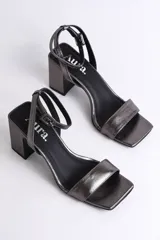 Sandalias plateadas de cuero con pulsera al tobillo y tacón cuadrado.
