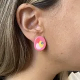 Par de aros con forma ovalada irregular, color verde lima con detalles en rosa y aplique de strass.