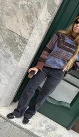 Pantalón de jean recto de tiro medio color gris oscuro con costuras verticales.