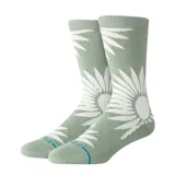 Medias Stance de caña media color verde con diseño de girasol blanco.