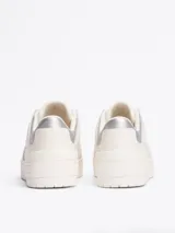 Zapatillas Tommy Hilfiger de corte bajo, color blanco con detalles en plateado en el talón. Confeccionadas en piel, con interior de poliéster y suela de goma. Presentan el logo de la marca en el lateral y en relieve en el talón.