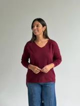 Sweater de punto en color bordó, con escote en V, mangas largas y diseño de corte recto con dobladillo ligeramente más largo en la parte posterior.