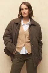 Campera capitoneada color marrón con botones veteados, bolsillos laterales de solapa y forro de satén con estampado animal print.