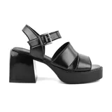 Sandalias de tacón alto Korium Abella color marrón, con plataforma y tiras cruzadas en el empeine. Cierre con hebilla en el tobillo.