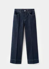 Jeans tiro medio de corte recto y diseño largo, confeccionados en tejido denim de algodón. Cuentan con cierre delantero de cremallera y botón, trabillas para cinturón, bolsillos delanteros y bolsillos de parche en la parte posterior, con costura del bajo ancha.