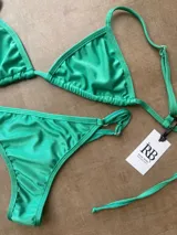 Conjunto de bikini verde esmeralda de dos piezas, con corpiño triangular de tirantes finos y bombacha cavada con tiras laterales.