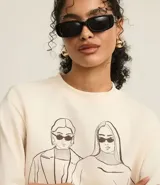 Saco de algodón color crema con cuello redondo y mangas largas. Tiene rib en cuello, puños y bajo. Cuenta con bordado delantero de mujeres fashionistas.