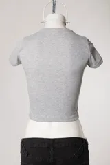 Remera baby tee blanca de morley, con ajuste al cuerpo, mangas cortas, cuello redondo y estampado con la inscripción 'Michigan' en estilo college.