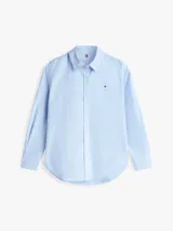 Camisa oxford Tommy Hilfiger de corte relaxed en color celeste, con cuello camisero, mangas largas y cierre frontal de botones. Presenta el logo de la marca bordado en el pecho.