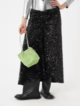 Falda midi negra cubierta de lentejuelas brillantes con detalle drapeado.