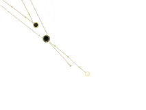 Collar doble de acero con baño de oro, con dijes circulares reversibles de nácar y ónix.