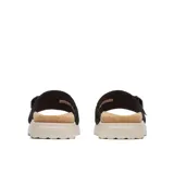 Sandalia Merrell modelo Fleur Slide, color negro, con parte superior de cuero, tira ajustable con hebilla, plantilla de corcho y suela blanca con plataforma.