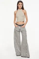Jean de denim celeste de tiro alto y silueta wide leg, con costuras marcadas, bolsillos funcionales, bolsillo trasero inferior con bordado y terminación desflecada en el ruedo.
