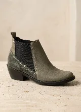 Bota tipo Chelsea de cuero negro con paneles laterales elásticos y taco bajo cuadrado. Presenta una combinación de texturas en el cuero y una presilla trasera para facilitar el calce.