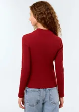 Camiseta de manga larga en color bordeaux, con cuello alto y diseño acanalado ajustado al cuerpo.