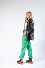 Pantalón de mujer color verde brillante, de corte holgado y tiro alto, con bolsillos laterales y cintura elástica.