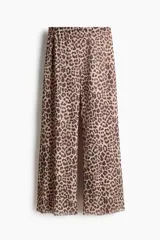 Pantalón de malla transparente con estampa de leopardo, corte holgado y piernas rectas, con cintura elástica revestida y forro de punto.