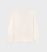 Buzo color crema con estampado azul marino que dice 'New York Health & Wellness Club Sporty & Rich Est. 1994'.