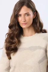 Buzo de tejido de punto con diseño jacquard estampado en tonos rosados y beige, de corte holgado, cuello redondo y mangas largas con puños acanalados.