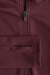 Campera deportiva de corte ajustado con capucha, cierre frontal completo y bolsillos laterales con cierre. Confeccionada en tejido funcional con tecnología de absorción de sudor, presenta mangas largas con aberturas para los pulgares.