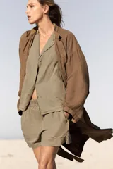 Camisa amarilla de lino con cuello solapa, escote pico, manga larga con botones y cierre frontal con botones.