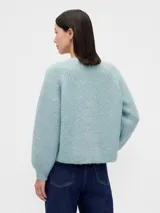 Saco de punto de textura suave en color celeste, con cuello redondo, cierre frontal de botones y mangas largas con puños ajustados.