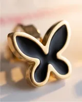 Caravana de acero con diseño de mariposa en color negro con borde dorado.