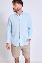 Camisa de corte regular con diseño de rayas verticales finas en tonos claros, cuello clásico y mangas largas con puños abotonados.