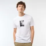 Remera blanca de manga corta con estampado fotográfico rectangular en el pecho y la inscripción "Road Stride".
