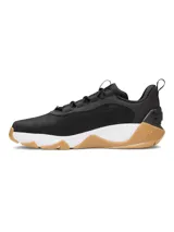 Championes de entrenamiento Under Armour Project Rock 8, color negro con entresuela blanca y suela de goma color caramelo. Presentan una parte superior de malla técnica con detalles en gamuza, lengüeta de neopreno perforada y contrafuerte externo en el talón para mayor estabilidad. Incorporan tecnología de amortiguación UA HOVR y suela UA TriBase para maximizar el contacto con el suelo y brindar flexibilidad.