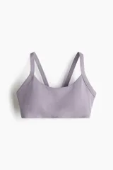 Top deportivo de sujeción media confeccionado en tejido funcional con tecnología SoftMove y DryMove. Presenta escote redondo, breteles anchos y copas forradas con relleno extraíble. Cuenta con elástico revestido en el bajo para un ajuste seguro.