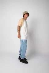 Remera estilo raglán color blanco en el cuerpo, con mangas en tono tostado y ribetes en color verde militar en el cuello y los puños.