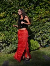 Falda larga de lino color beige con volados de rafia en capas, tajos laterales y cintura elástica en la parte posterior.