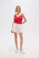 Short blanco con rayas verticales finas en color negro, cintura elastizada y volados en el ruedo.