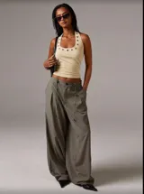 Musculosa negra con cuello halter y detalle de ojales metálicos.