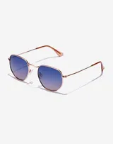 Gafas de sol unisex con montura metálica color oro rosa y lentes hexagonales con degradé de azul a rosa.