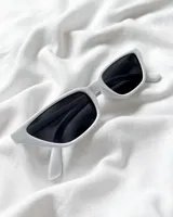 Lentes de sol blancos con forma rectangular y cristales negros.