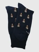 Calcetín de largo medio en color azul marino con estampado de perros pequeños en tonos marrones y blancos.