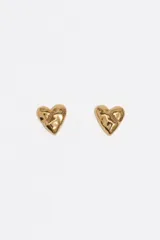 Caravanas en forma de corazón con superficie texturizada y acabado dorado. Están confeccionadas íntegramente en latón.