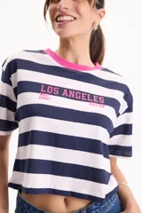 Remera de algodón crop, rayada en color azul marino y blanco, con cuello redondo fucsia y estampa frontal con texto en color fucsia.