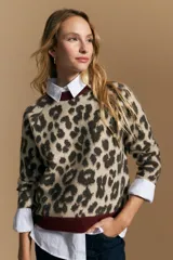 Sweater de tejido jacquard con estampado animal print, de silueta relajada y manga larga. Presenta cuello redondo y bordes en contraste de color bordó.