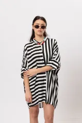 Camisa de rayas blanco y negro, de corte oversize y mangas cortas holgadas.