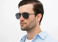 Lentes de sol INVU modelo B1306B, estilo aviador, con montura metálica color gris plomo y cristales polarizados negros.